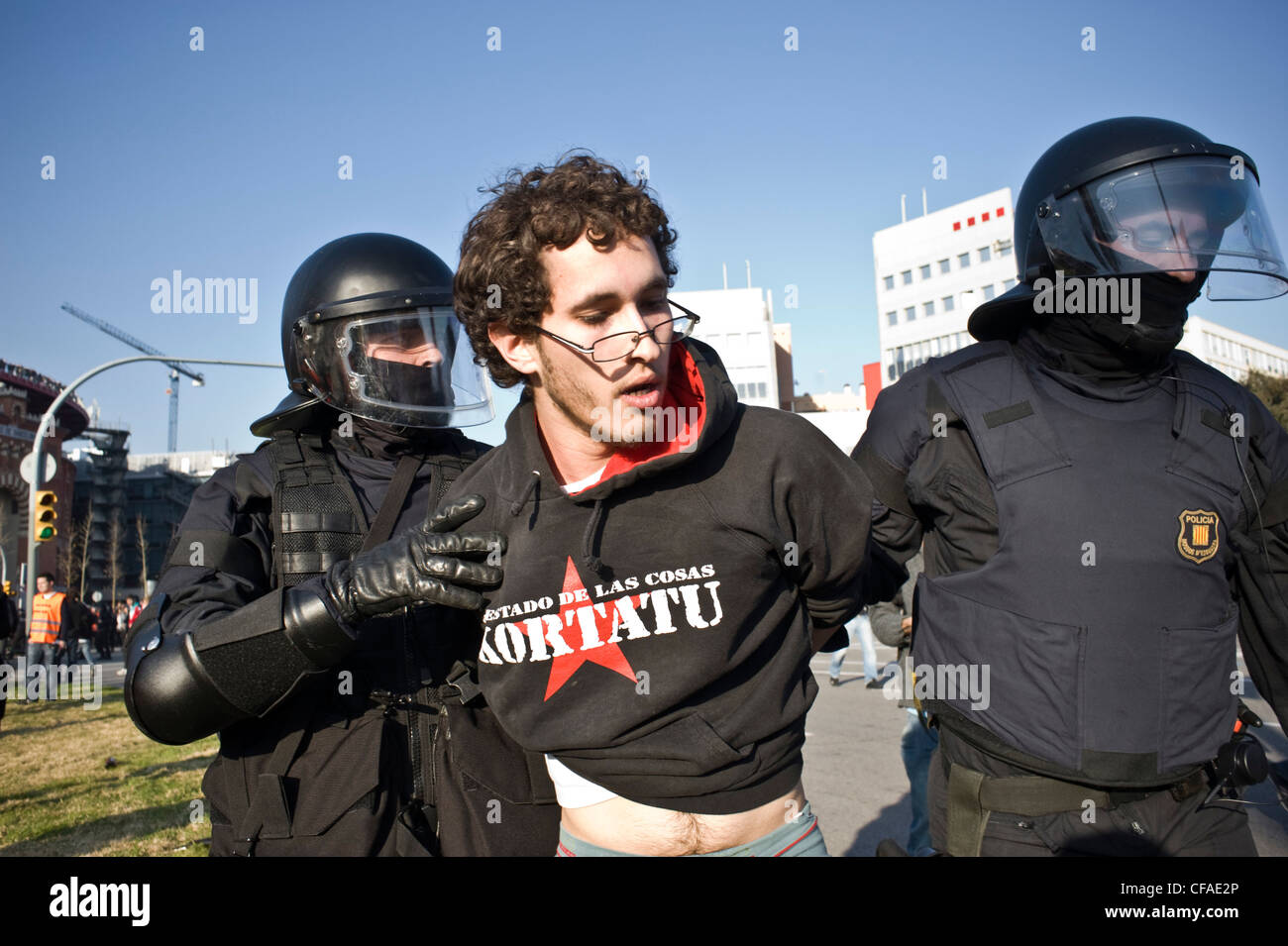 Arrest of a demonstrator by riot police during the disturbances produced in the vicinity of Mobile World Congress in Barcelona. Stock Photo