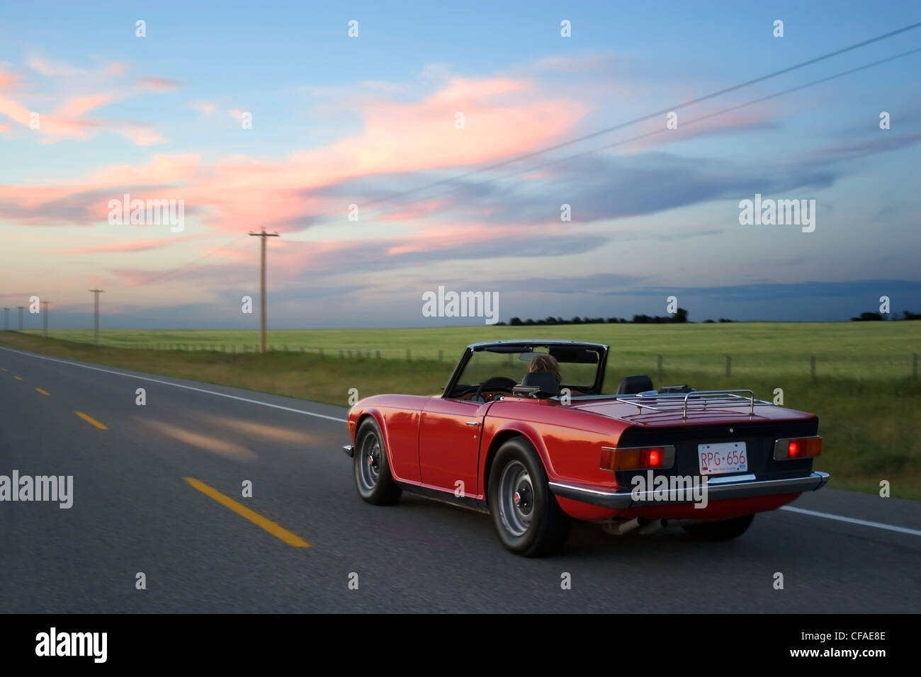 Woman driving red sports car on rural highway, High River, Alberta, Canada Stock Photo Alamy