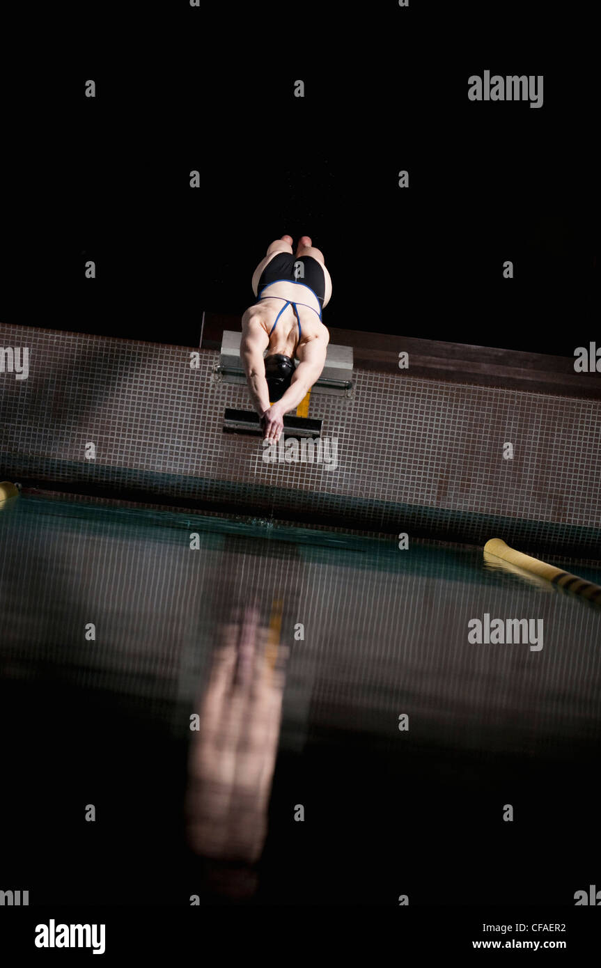Swimmer diving into swimming pool Stock Photo Alamy