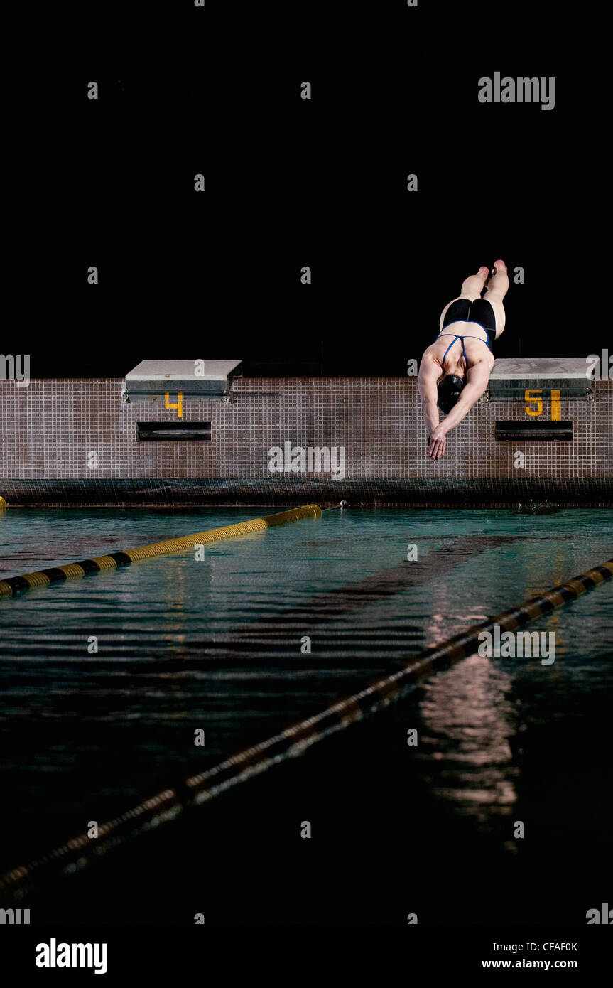 Swimmer diving into swimming pool Stock Photo Alamy