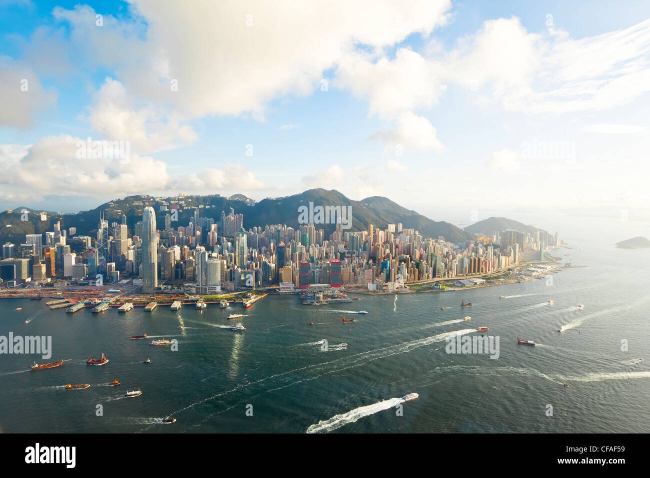 Elevated view across the busy Hong Kong harbour, Central district of Hong Kong Island and Victoria Peak, Hong Kong, China Stock Photo