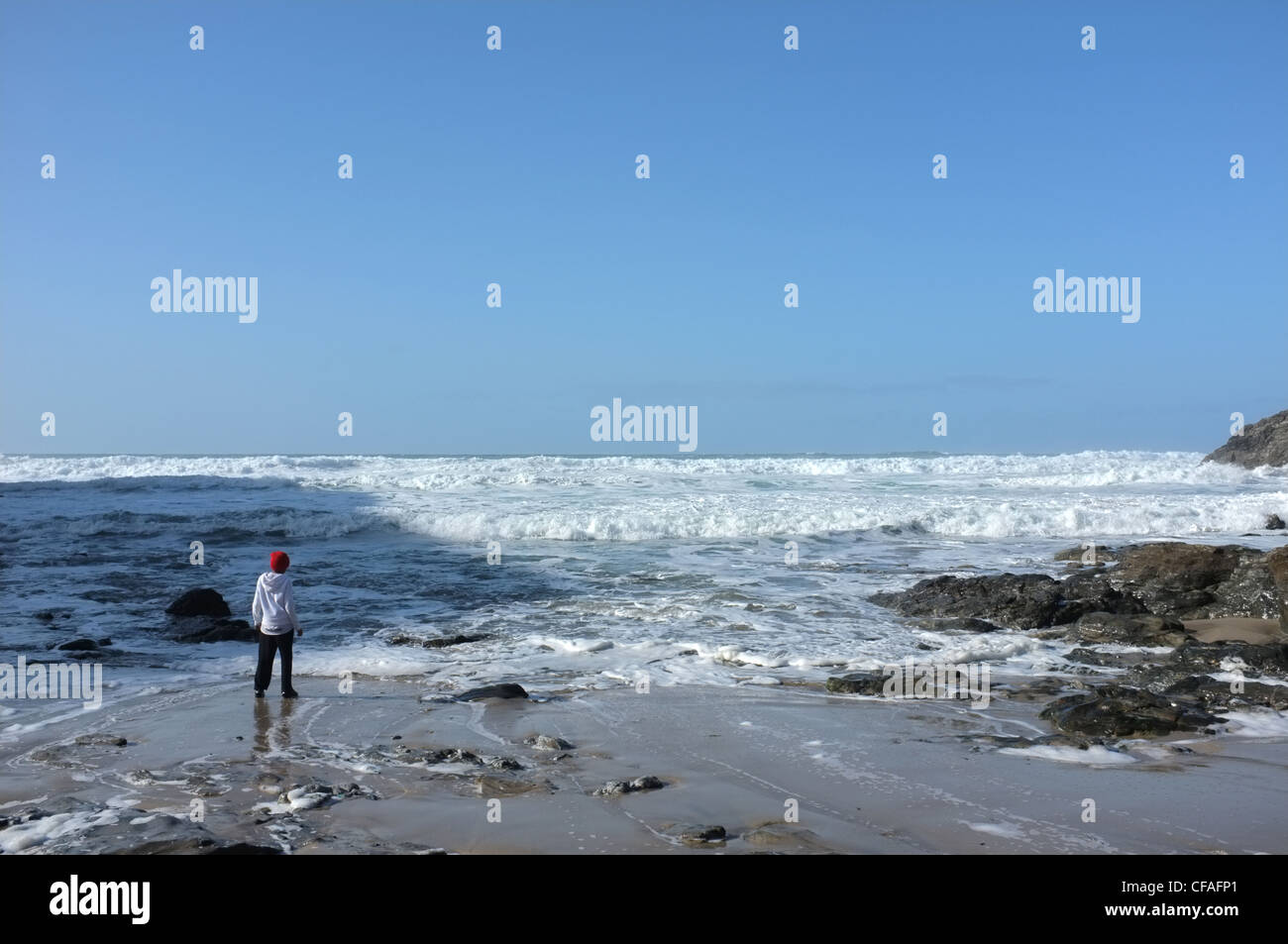 A black child on the beach at St Agnes, Cornwall, UK Stock Photo