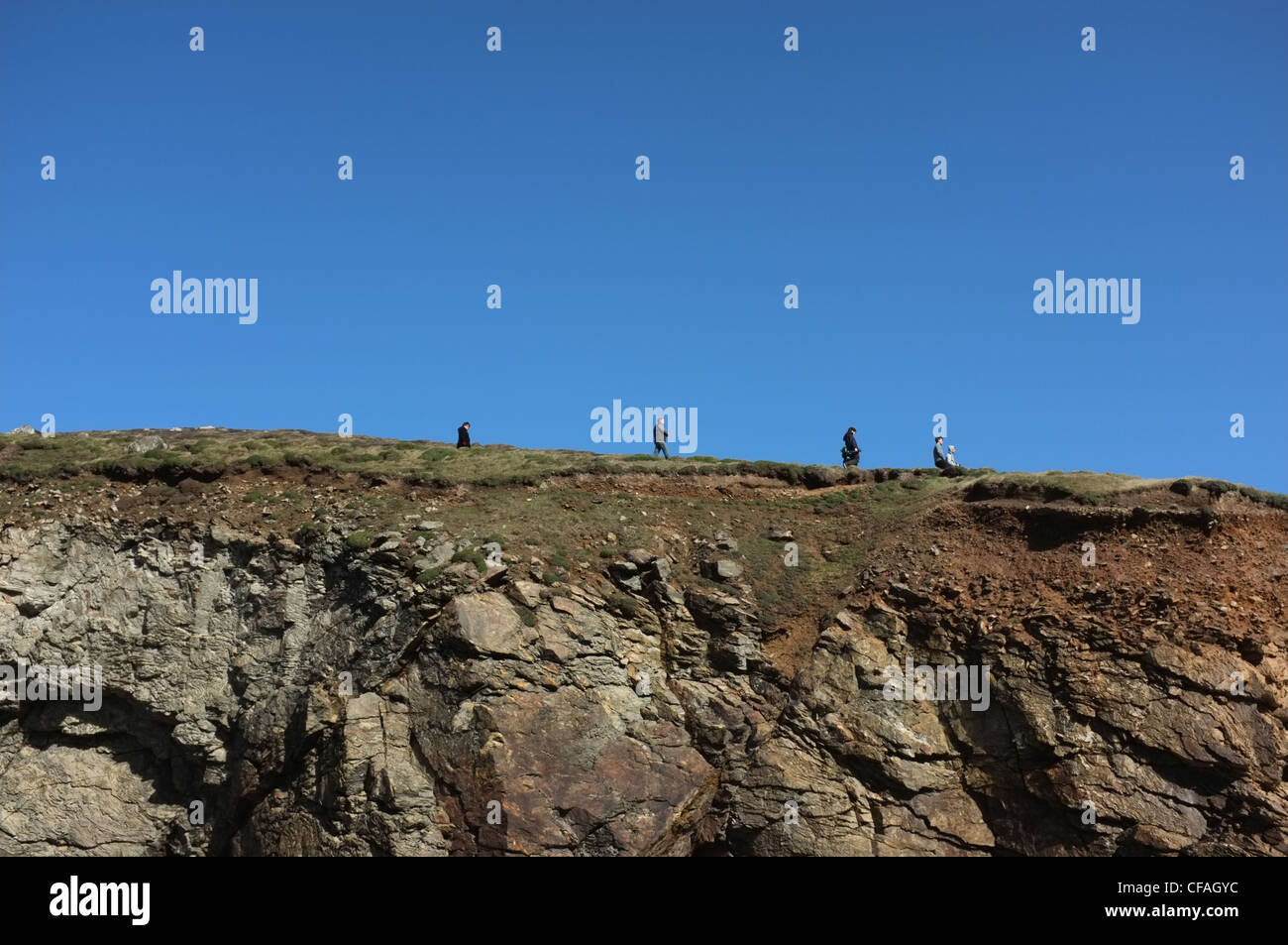 Walkers on the hills above St Agnes, Cornwall in winter. Stock Photo