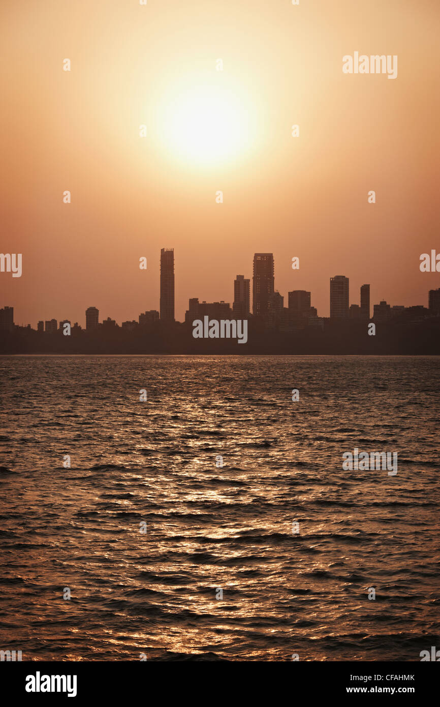 Silhouette of urban skyline on water Stock Photo