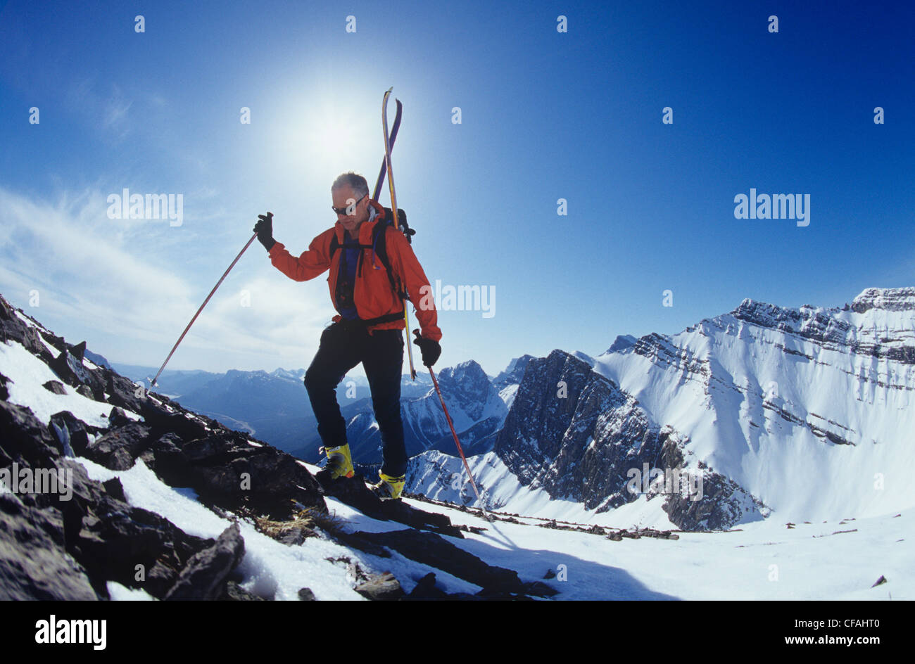 A skier boot packing up to the summit, Grassi Peak, Canmore, Alberta, Canada. Stock Photo