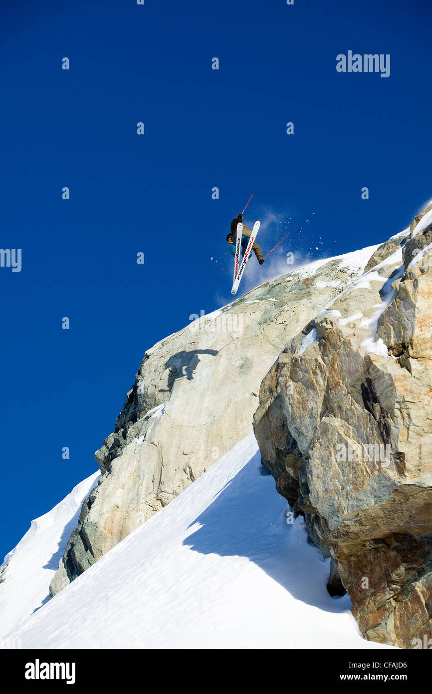 Man skiing over a rock cliff on Brandywine Mountain, Coast Mountains ...