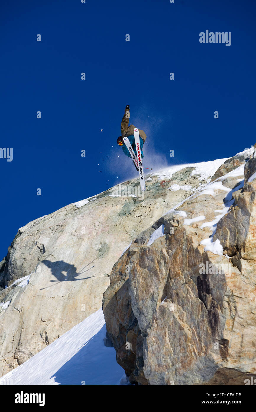 Man skiing over a rock cliff on Brandywine Mountain, Coast Mountains ...