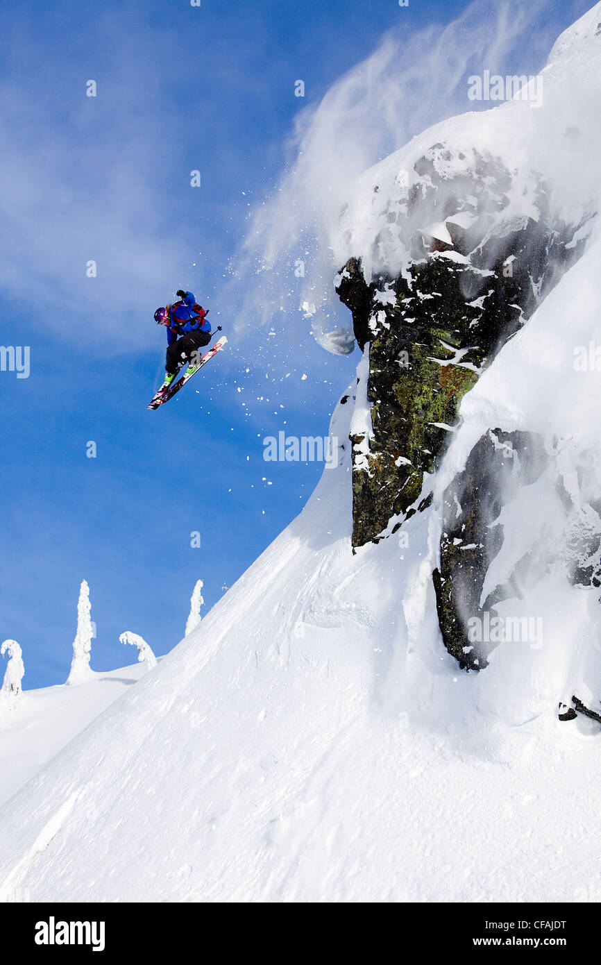 Man skiing over a rock cliff in the Whistler backcountry, Coast Mountains, British Columbia