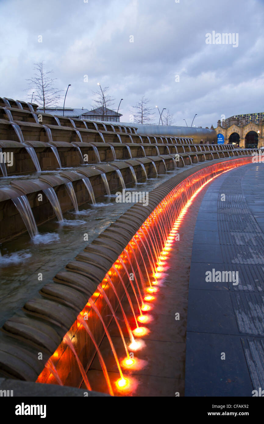 Sheffield train station at night with illuminated fountains and water