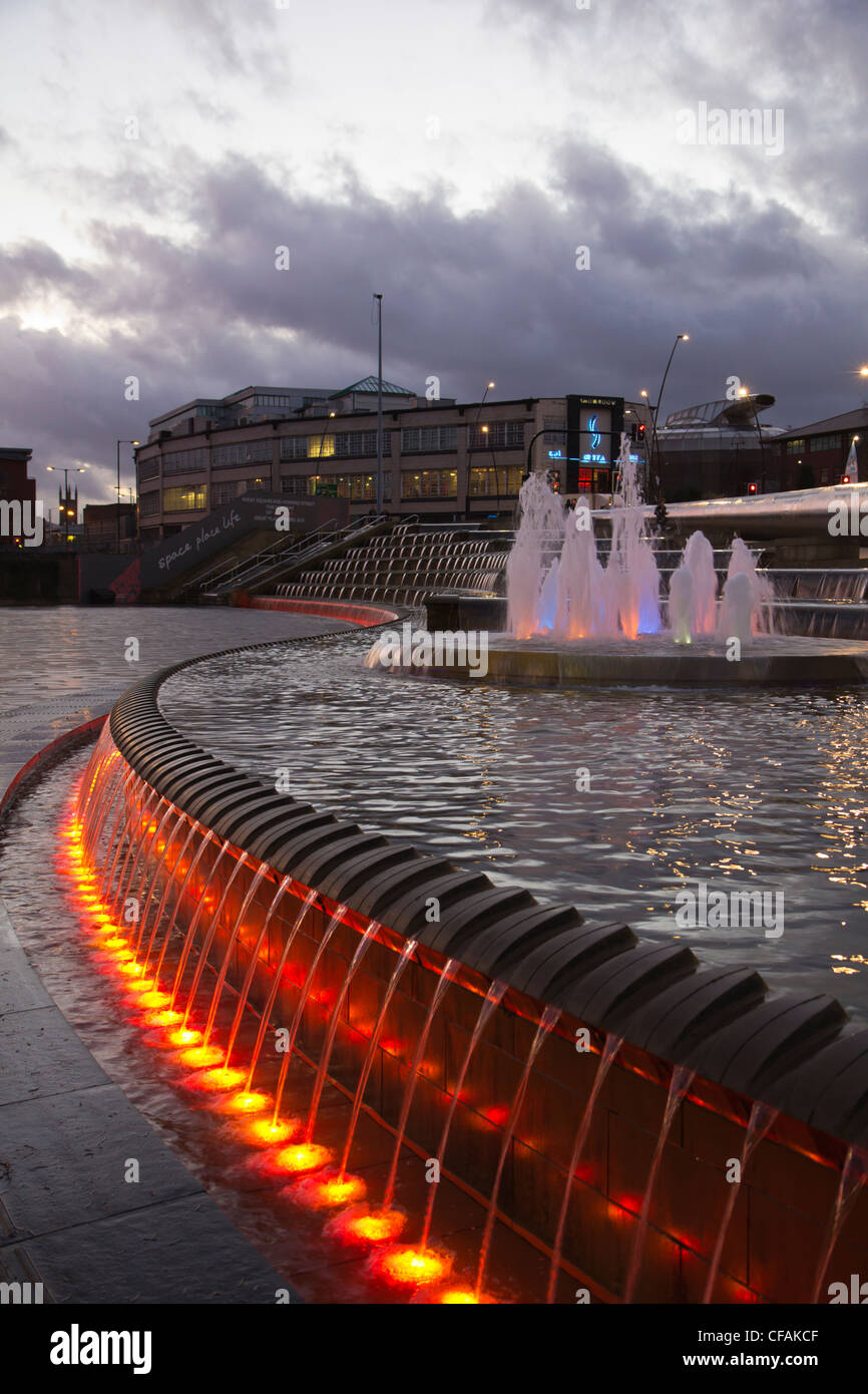 Sheffield train station at night with illuminated fountains and water