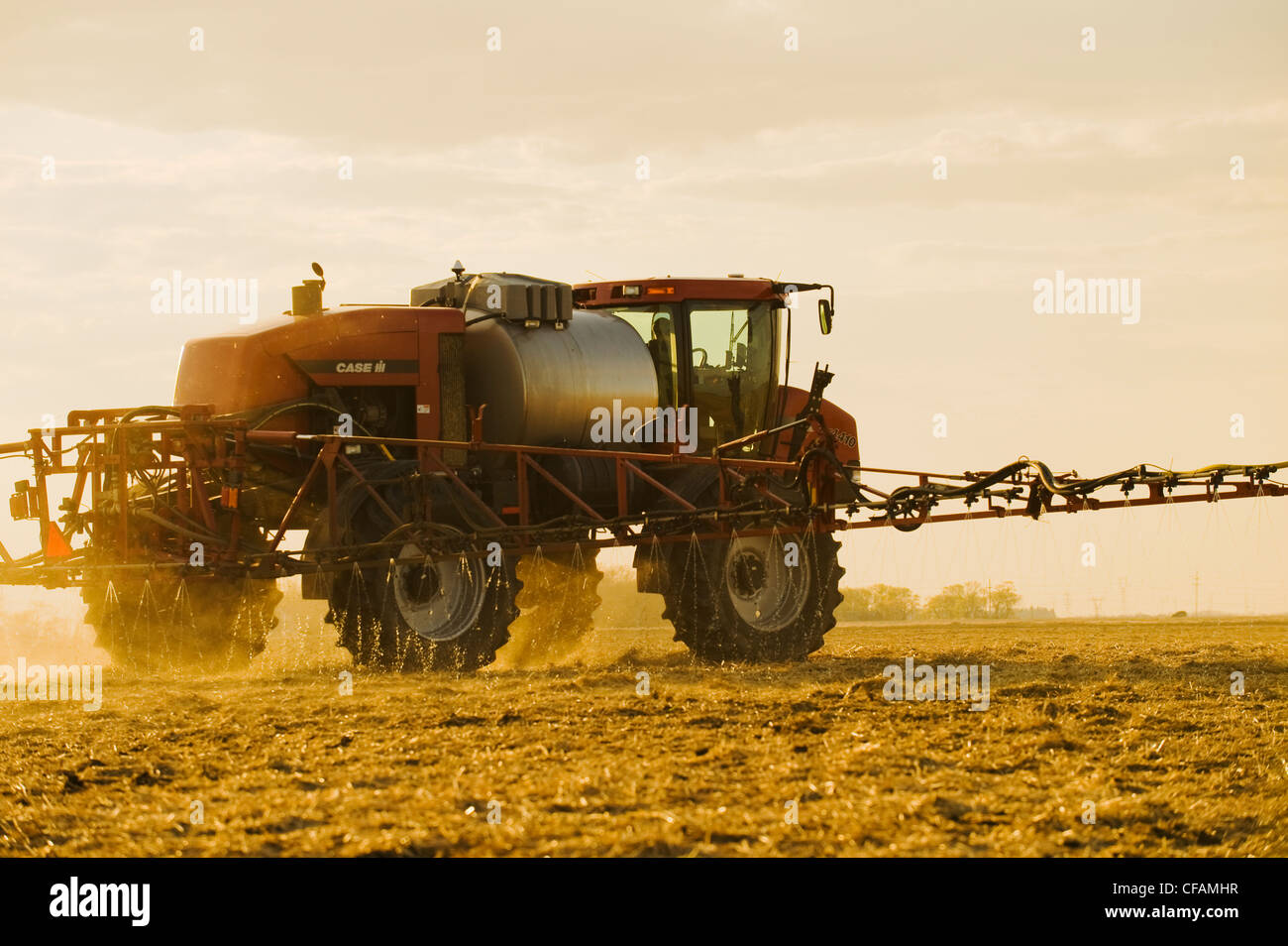 a high clearance sprayer applies liquid fertilizer on a newly seeded ...