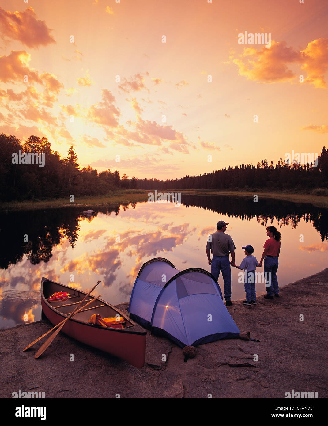 Family camping on riverbank, Whiteshell River, Whiteshell Provincial Park, Manitoba, Canada Stock Photo