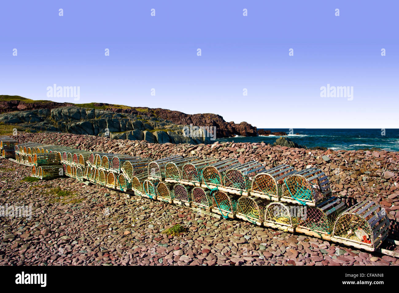 Lobster traps stacked and lined up on beach at Tickle Cove, Newfoundland and Labrador, Canada. Stock Photo