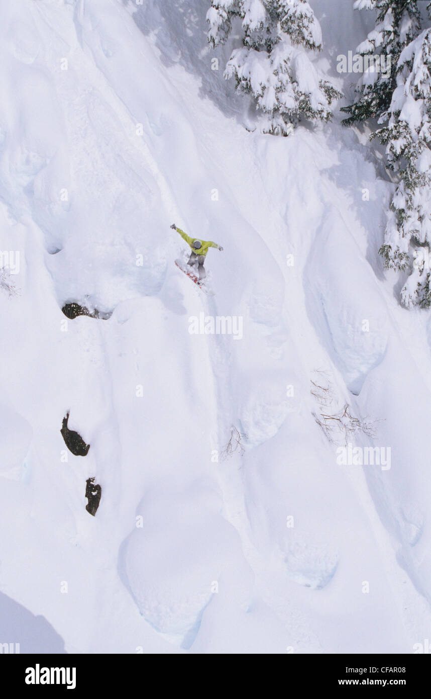 A snowboarder taking a massive jump off the pillows at Shames Mountain, Terrace, British Columbia, Canada Stock Photo