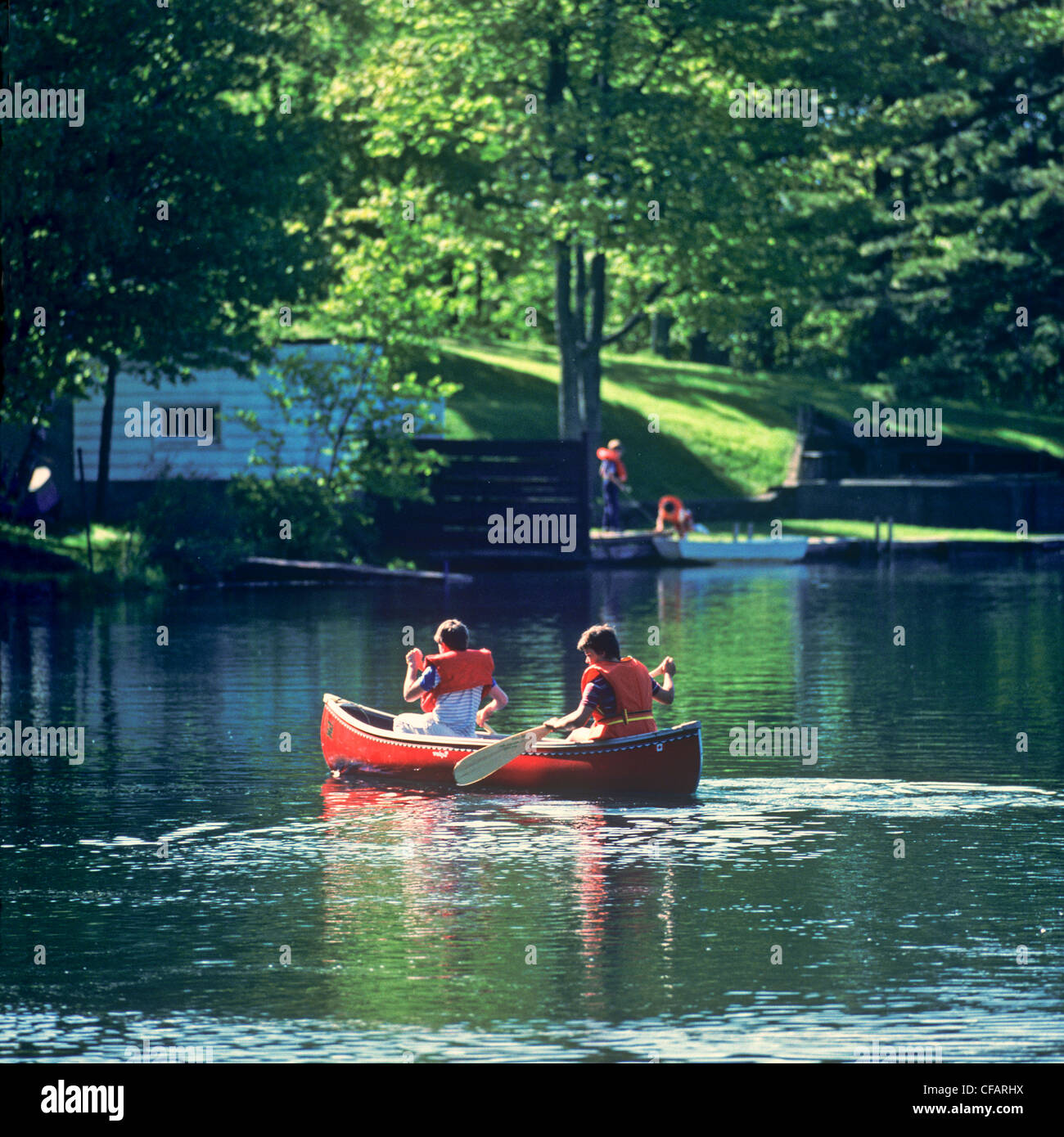 Two young boys canoeing on Chocolate Lake, Halifax, Nova Scotia, Canada