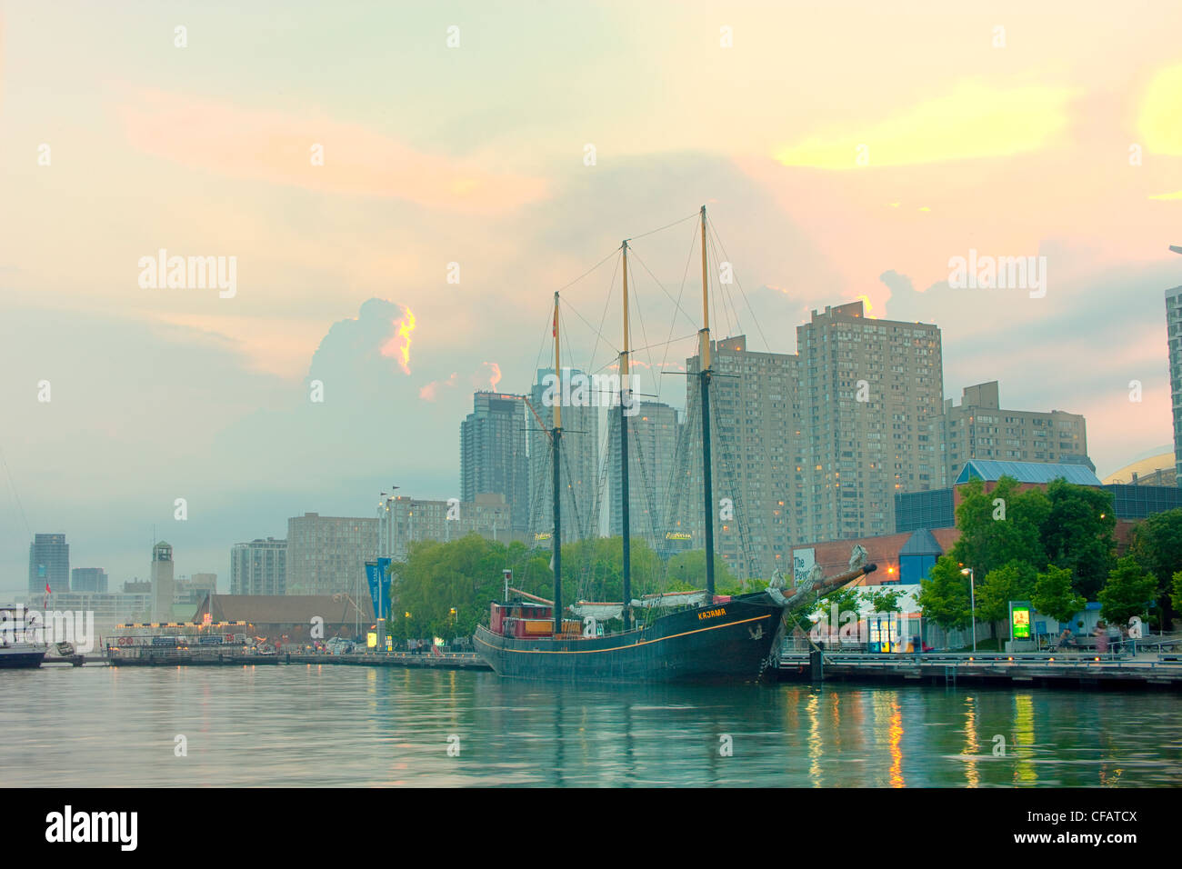 Sailing ship and tour boat docked at Toronto waterfront at dusk, Ontario, Canada. Stock Photo