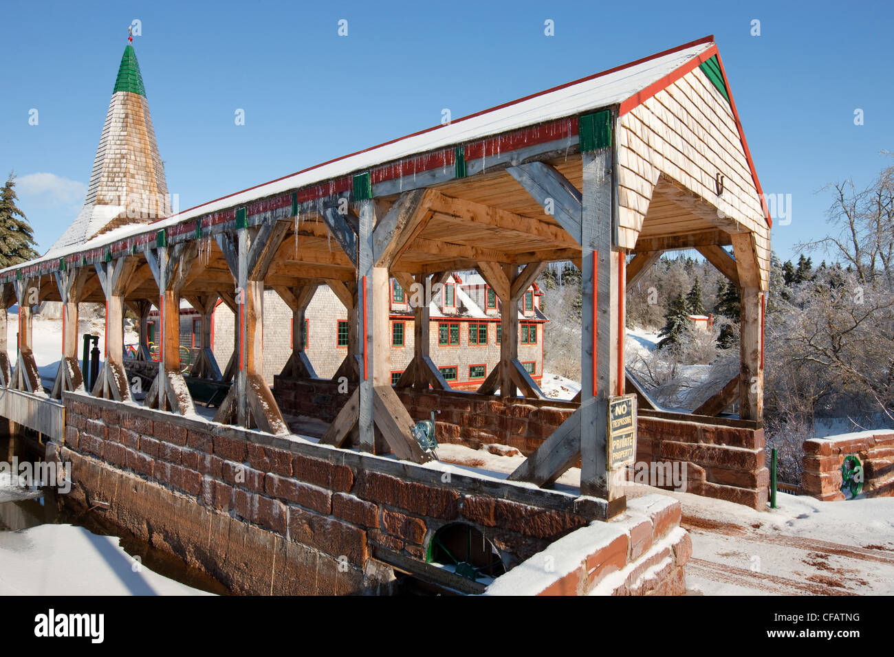 Mill and covered bridge in winter along Hunter River, Prince Edward Island, Canada Stock Photo