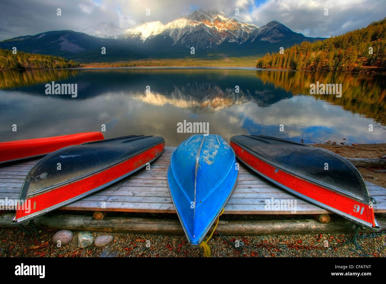 Beached canoes on dock, Pyramid Lake, Jasper National Park, Alberta, Canada Stock Photo