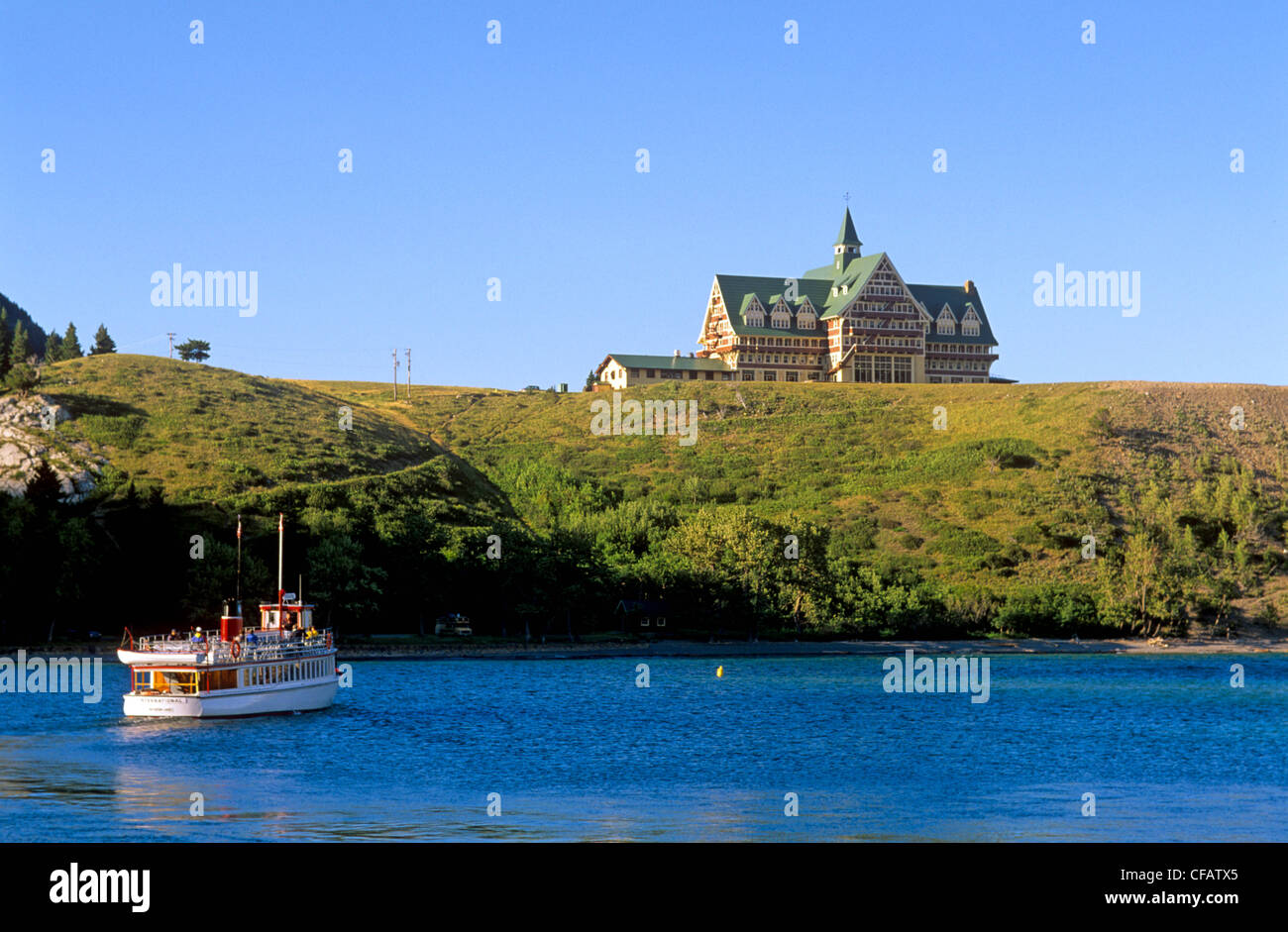 Tour boat in front of Prince of Wales Hotel, Waterton National Park, Alberta, Canada. Stock Photo