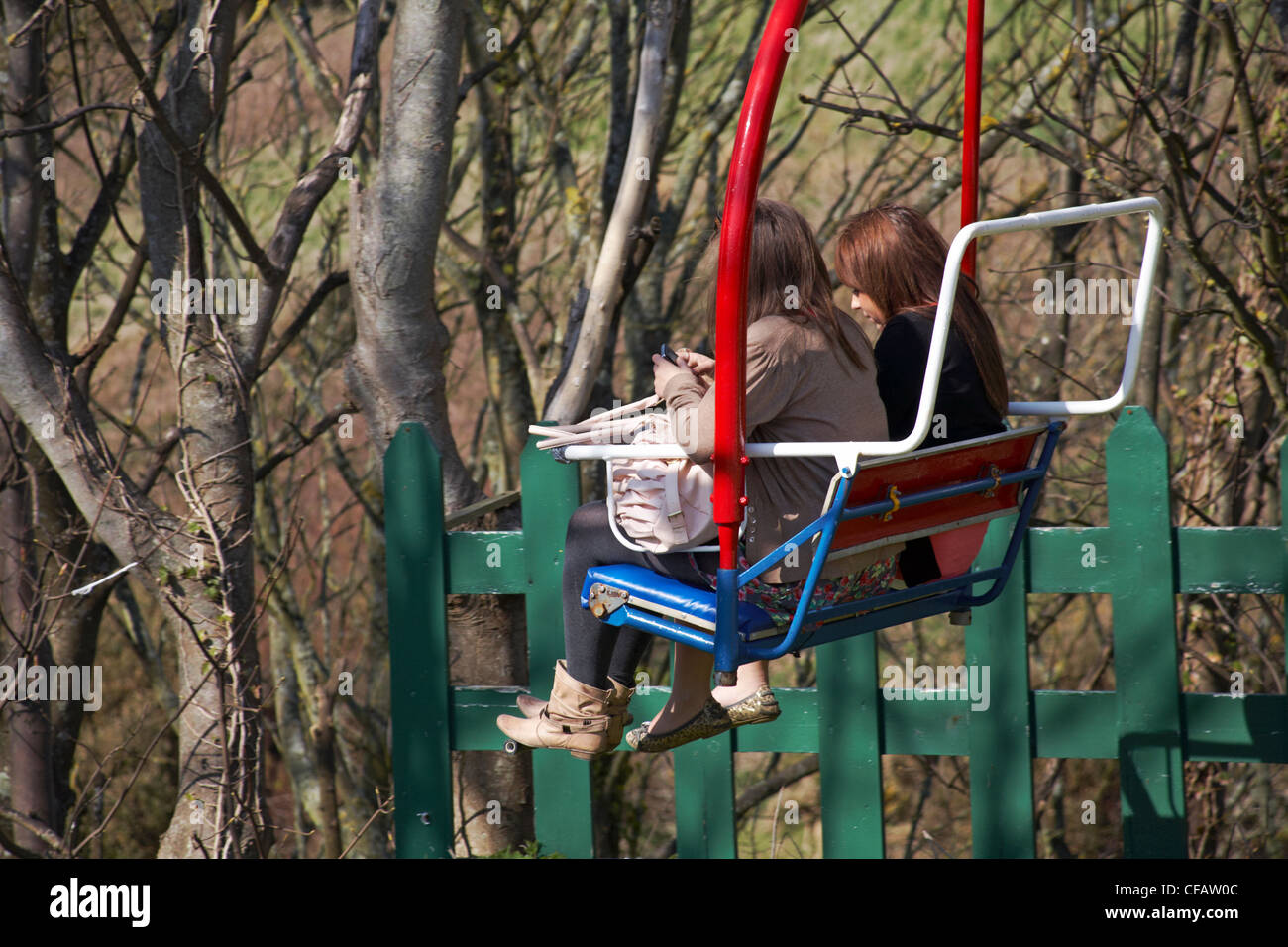 taking the easy way down two young women on chairlifts chair lifts at