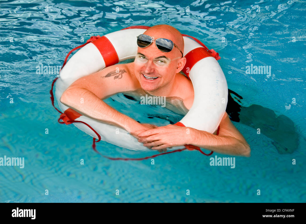 Man, water, swimming, floatation, life preserver, swimming ring, pool Stock Photo