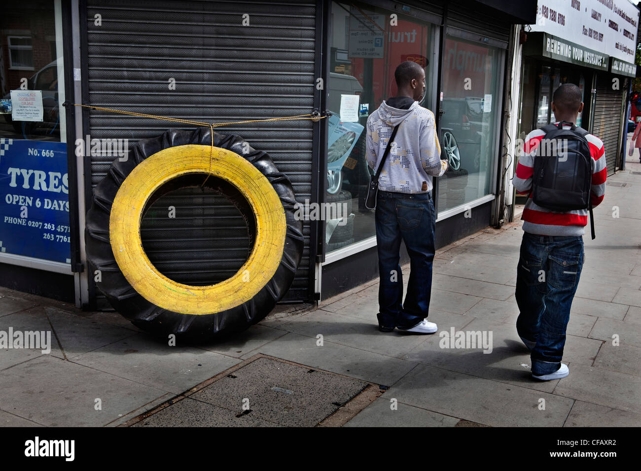 Huge car tire in front of a shop, Holloway road, London Stock Photo