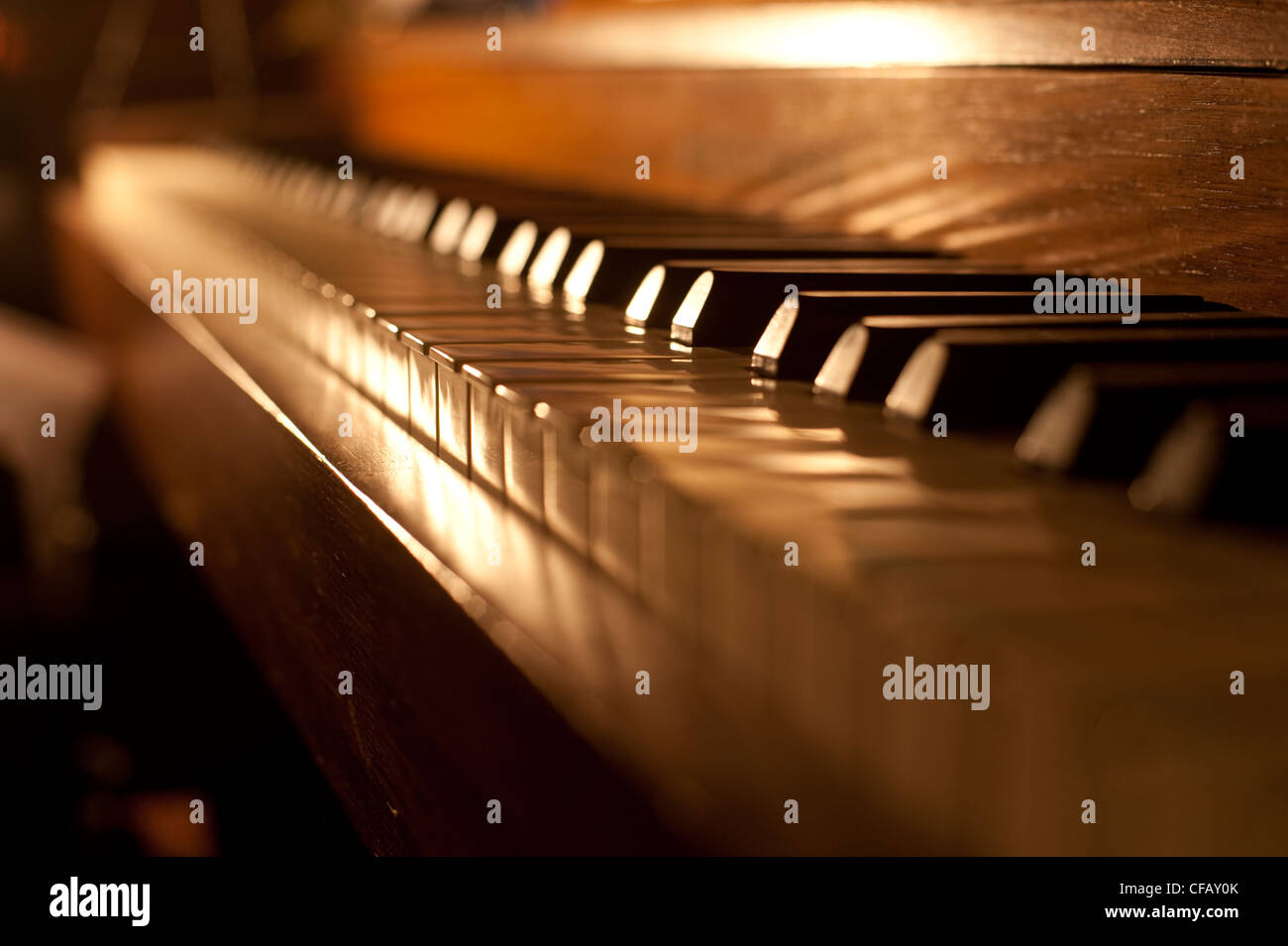 Closeup of antique piano keys and wood grain with sepia tone Stock Photo