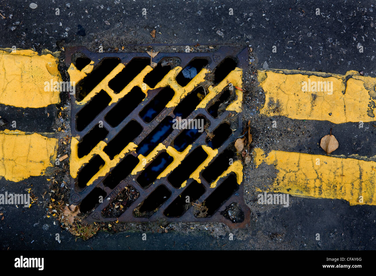 Yellow painted lines to show no parking, crossing a drain, on London