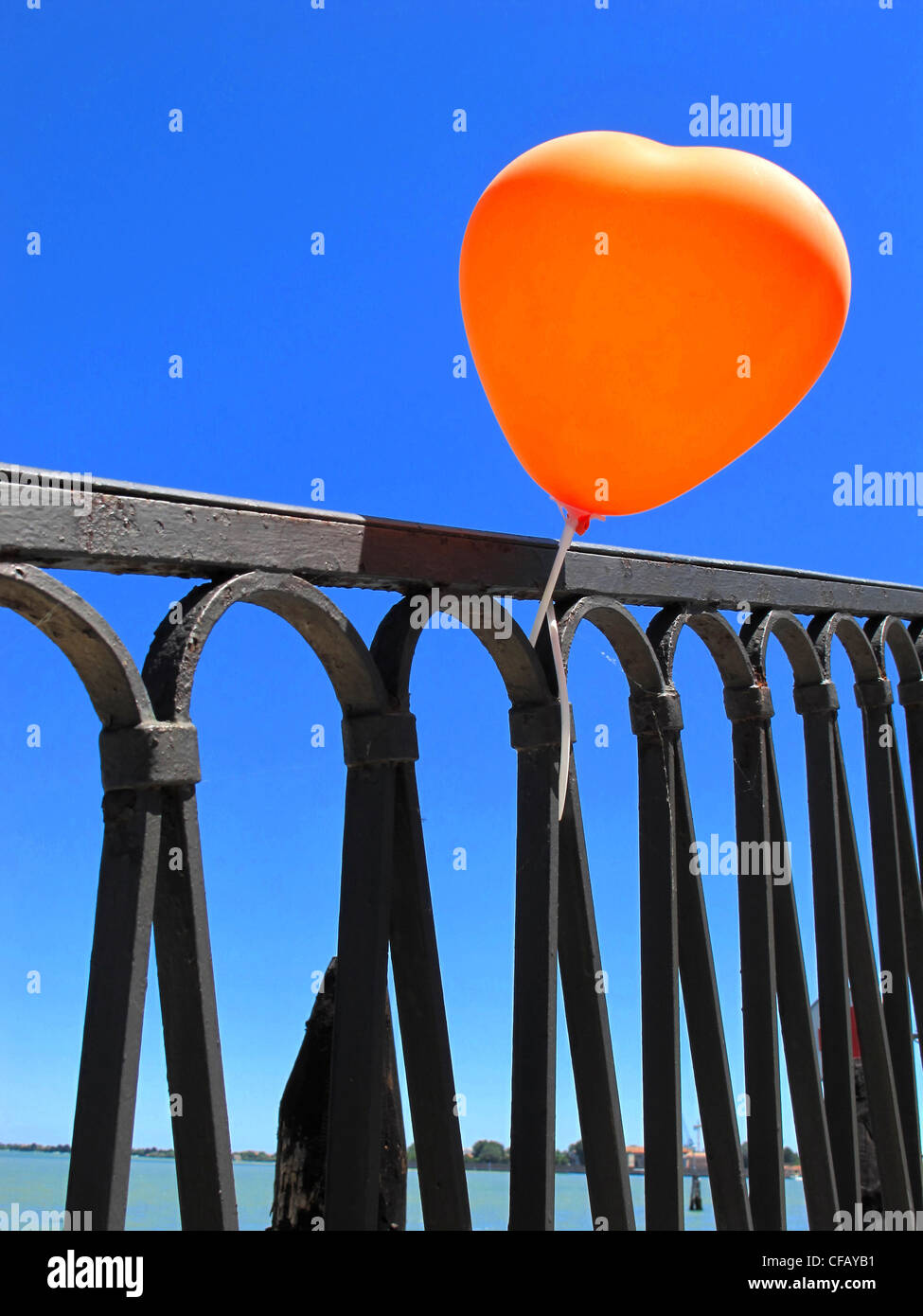 Heart, love, symbol, concepts, emotion, balloon, red, fence, railing Stock Photo
