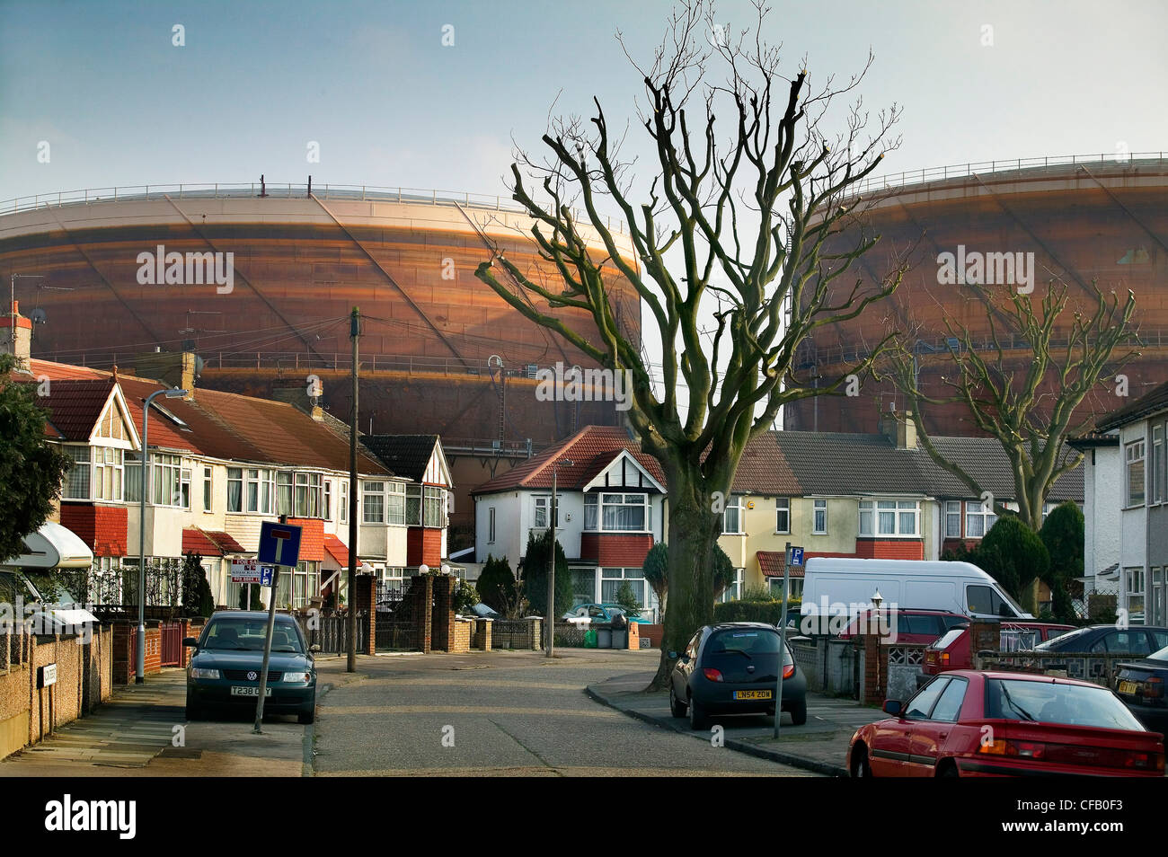 Gasometer behind suburban homes Stock Photo