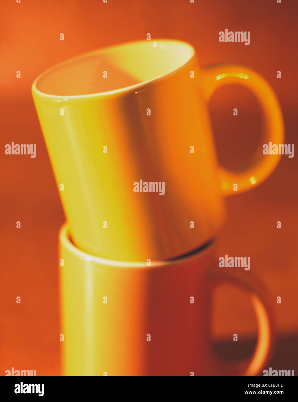 Still Yellow coffee mugs, stacked Stock Photo Alamy