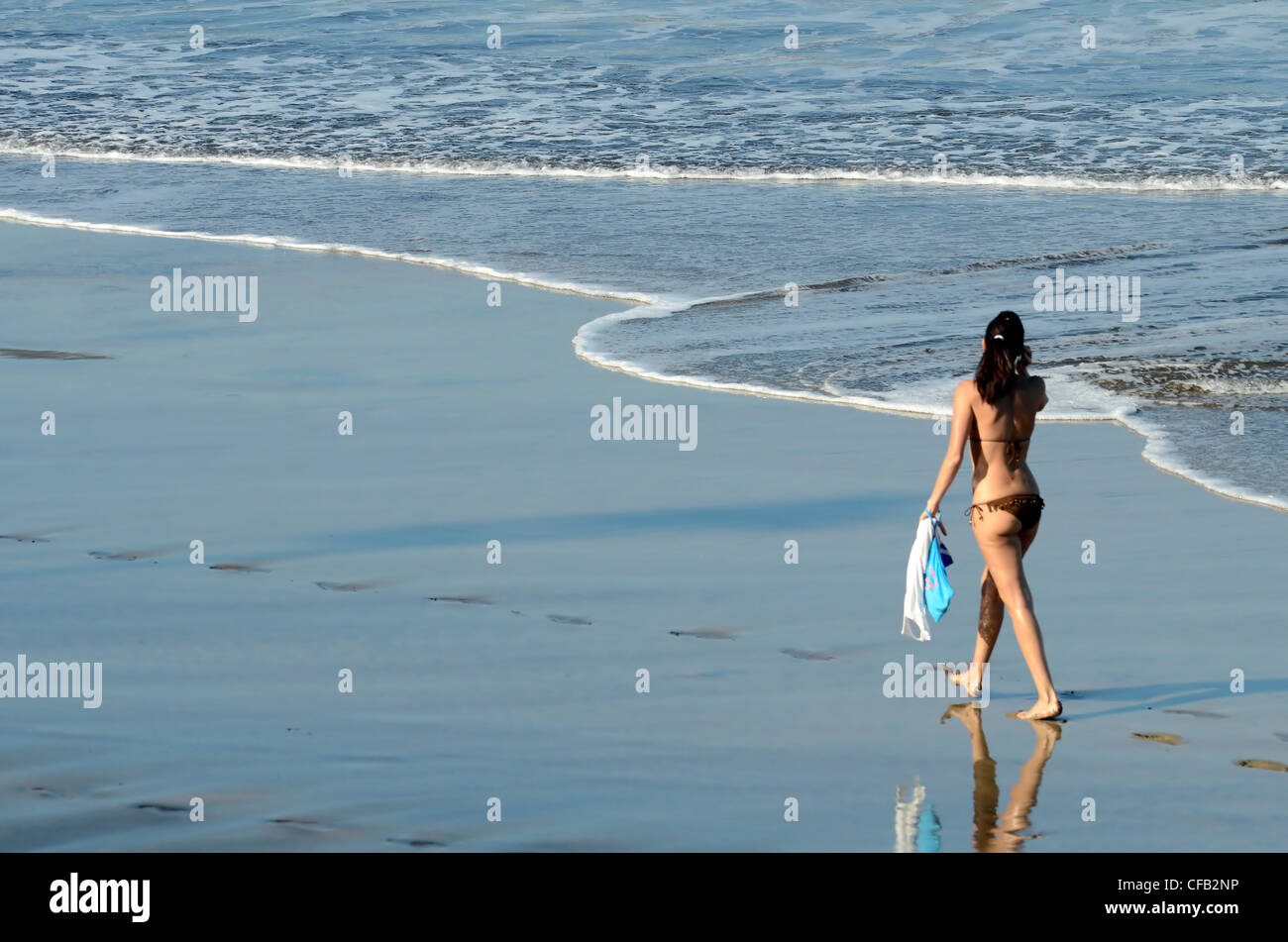 woman walking by the sea, winter in canary island Stock Photo