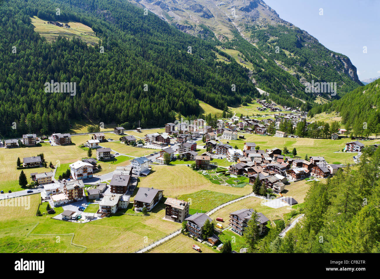 small swiss village settlement in green deep wooded valley in canton Valais Switzerland Stock Photo