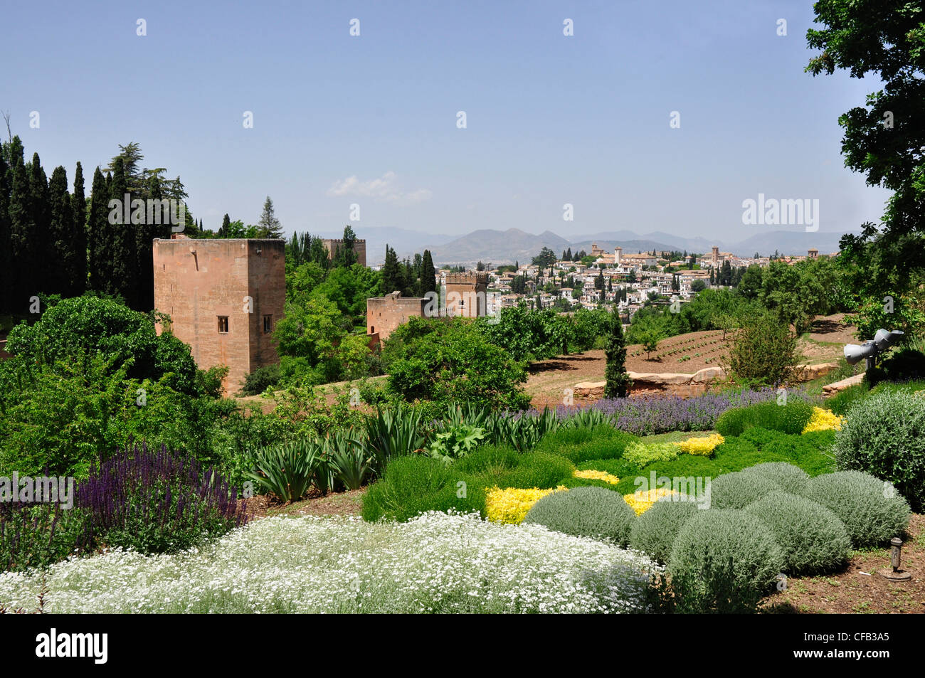 Spain - Andalucia - Granada - view over the gardens of the Alhambra Palace - backdrop of Granada town and mountains. Stock Photo