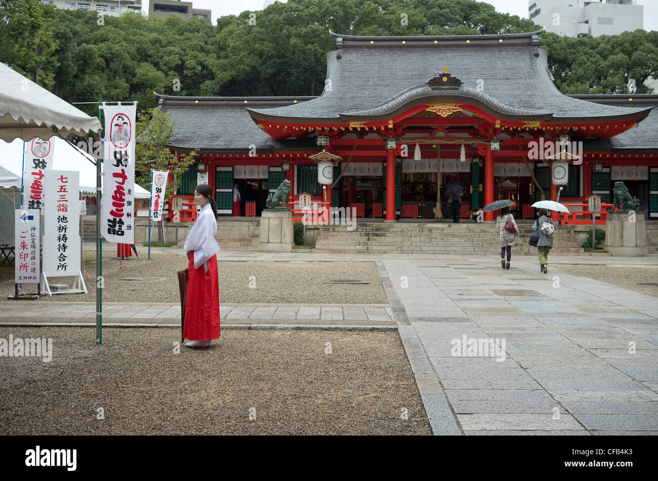 traditionally dressed, young Japanese woman at Ikuta shrine, Kobe, Japan Stock Photo