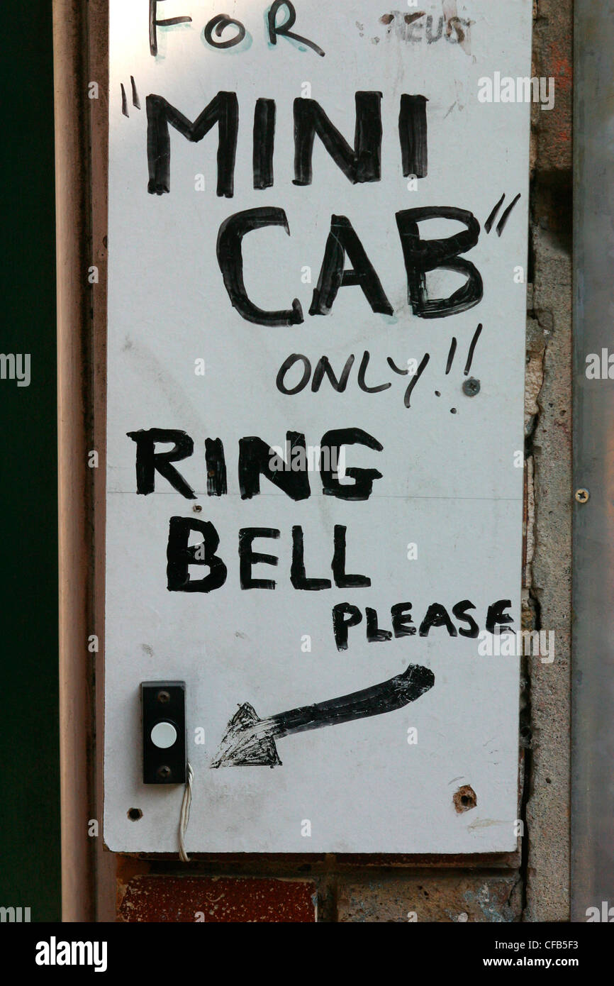 Sign for mini-cab office door and bell, Hoxton Stock Photo