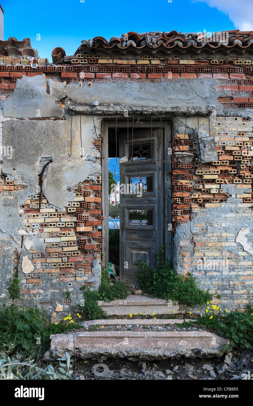 Old abandoned brick house ruins in Greece, broken entrance detail Stock Photo