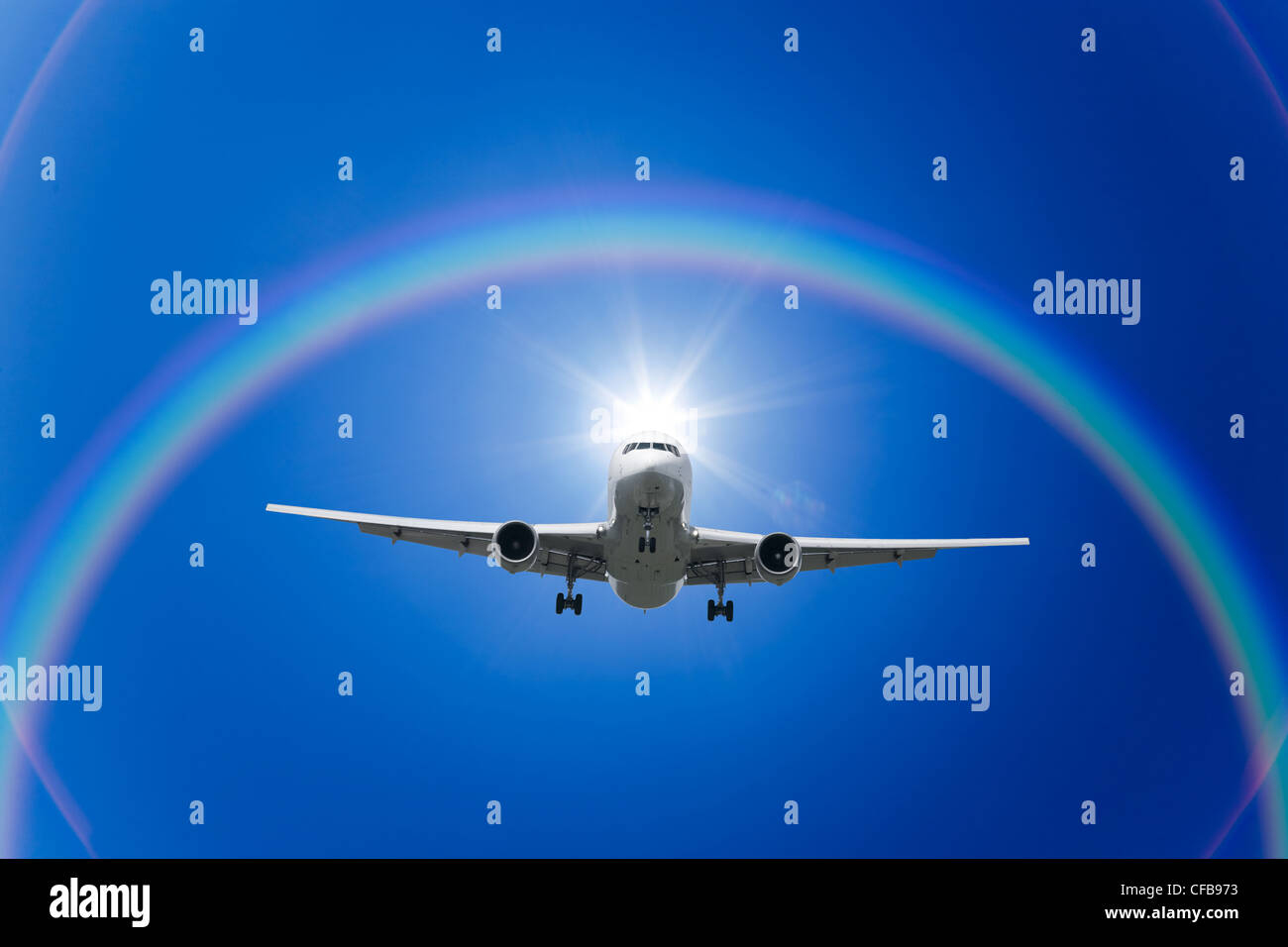 A jetliner aeroplane flying with rainbow in blue sky Stock Photo - Alamy