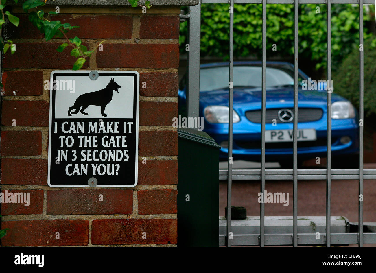 Guard dog sign outside wealthy property Stock Photo