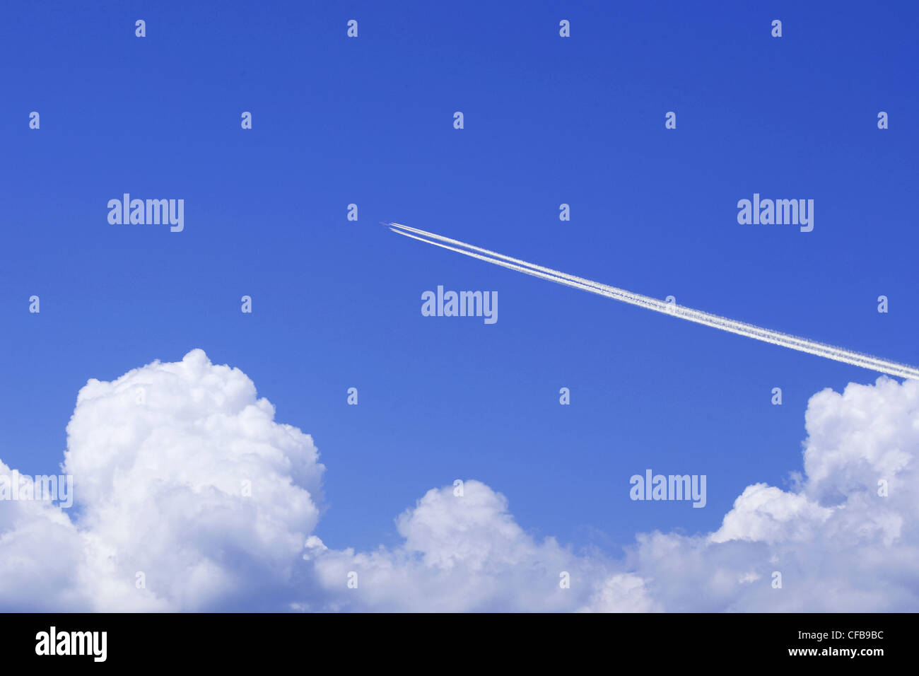 A jetliner aeroplane flying over white clouds Stock Photo - Alamy