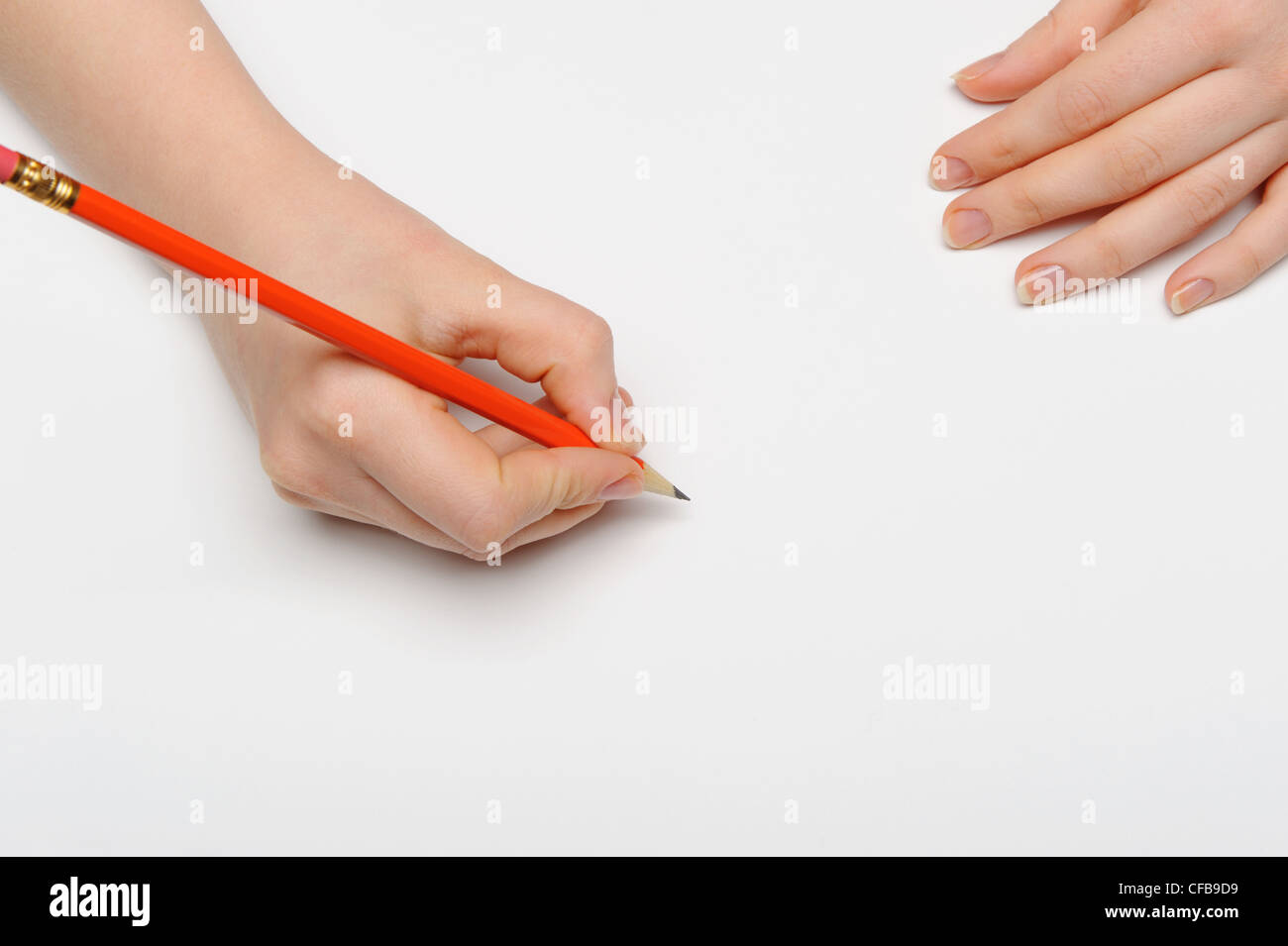 Hand with pencil. Over grey empty a paper. Imitation to write Stock Photo