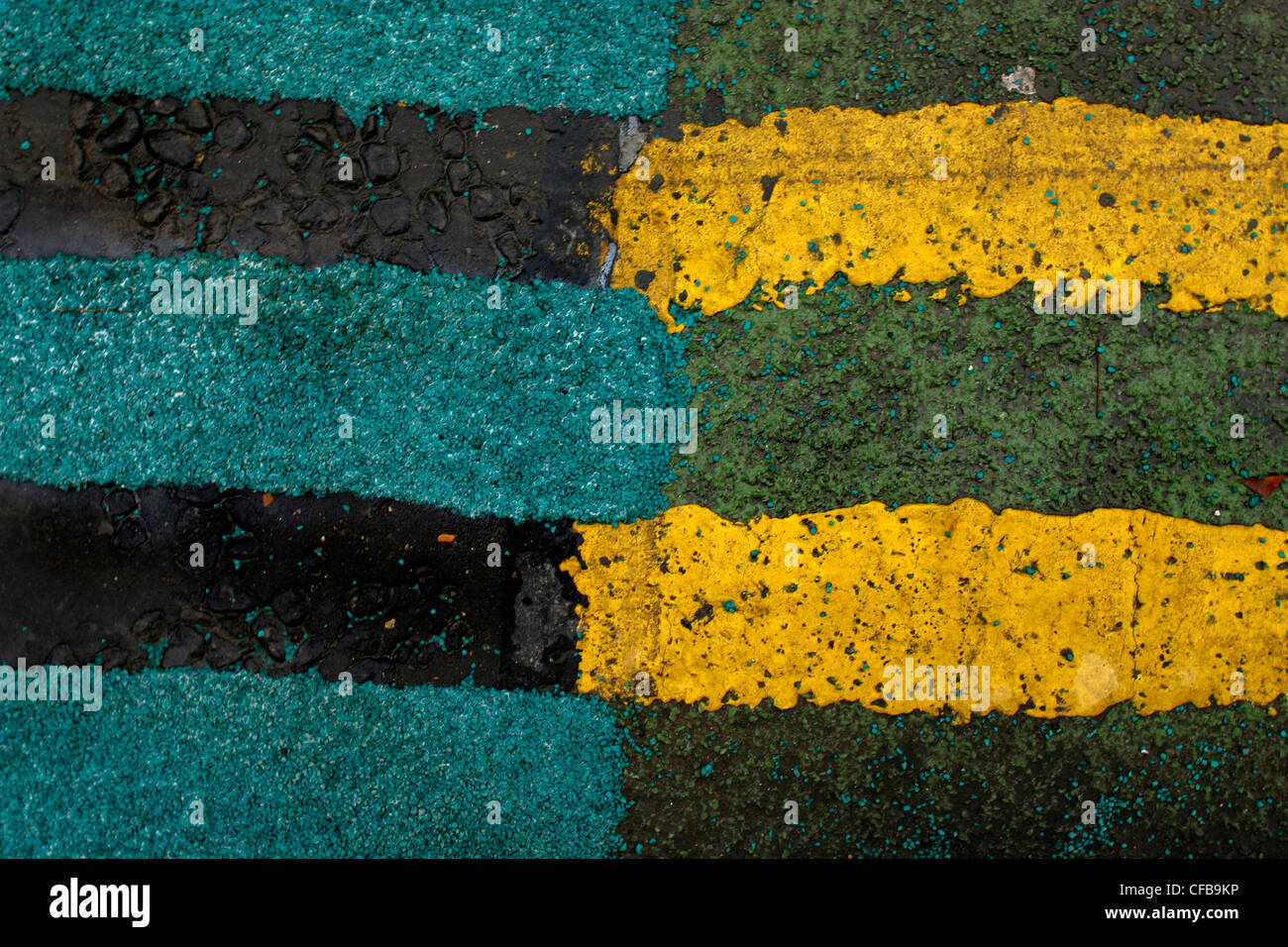 Green & yellow painted lines to show no parking on road, London UK
