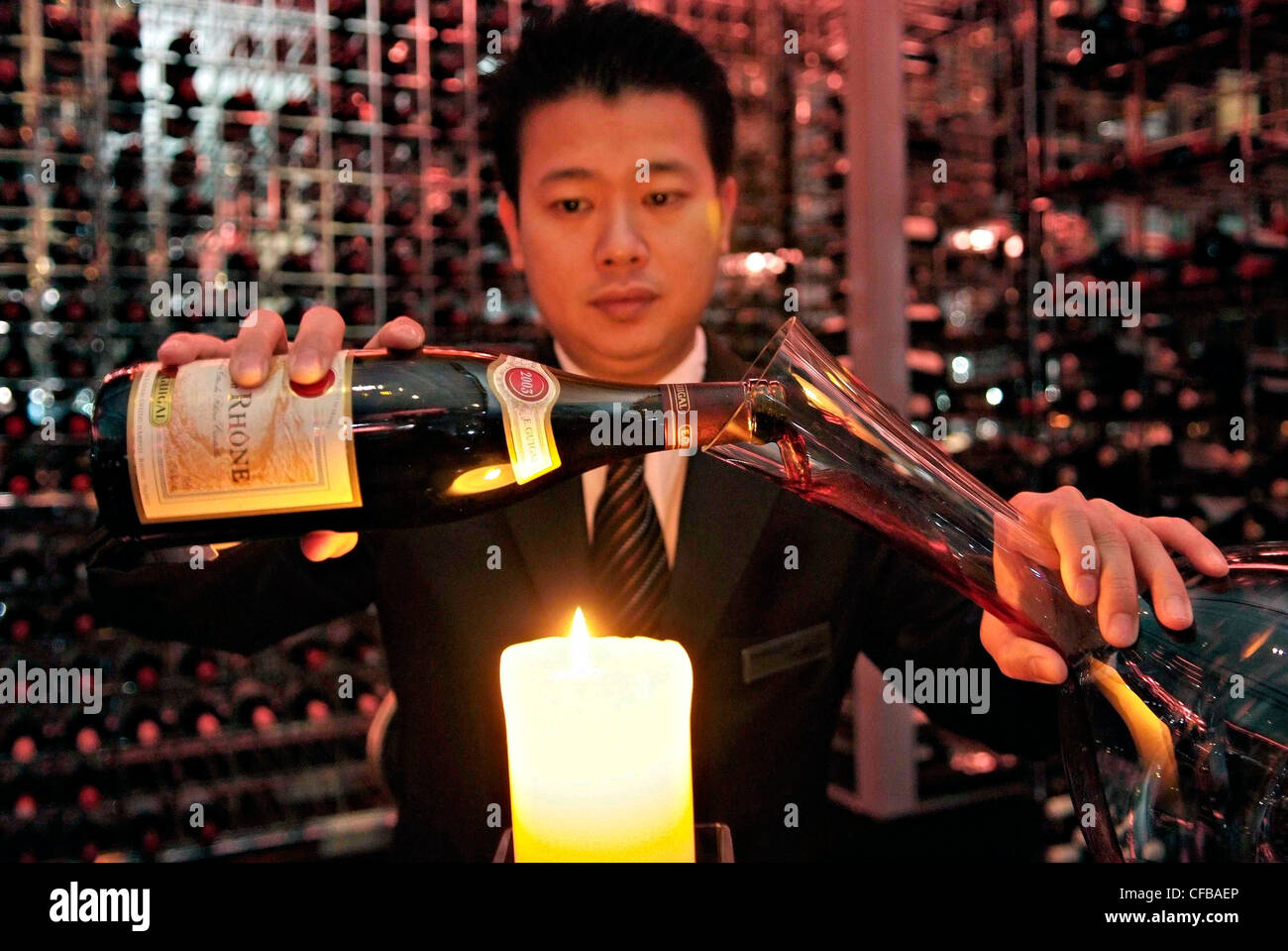 CHINA -MACAU SAR MGM Grand Hotel Wine cellar, Chinese Sommelier decants French Burgundy Stock Photo