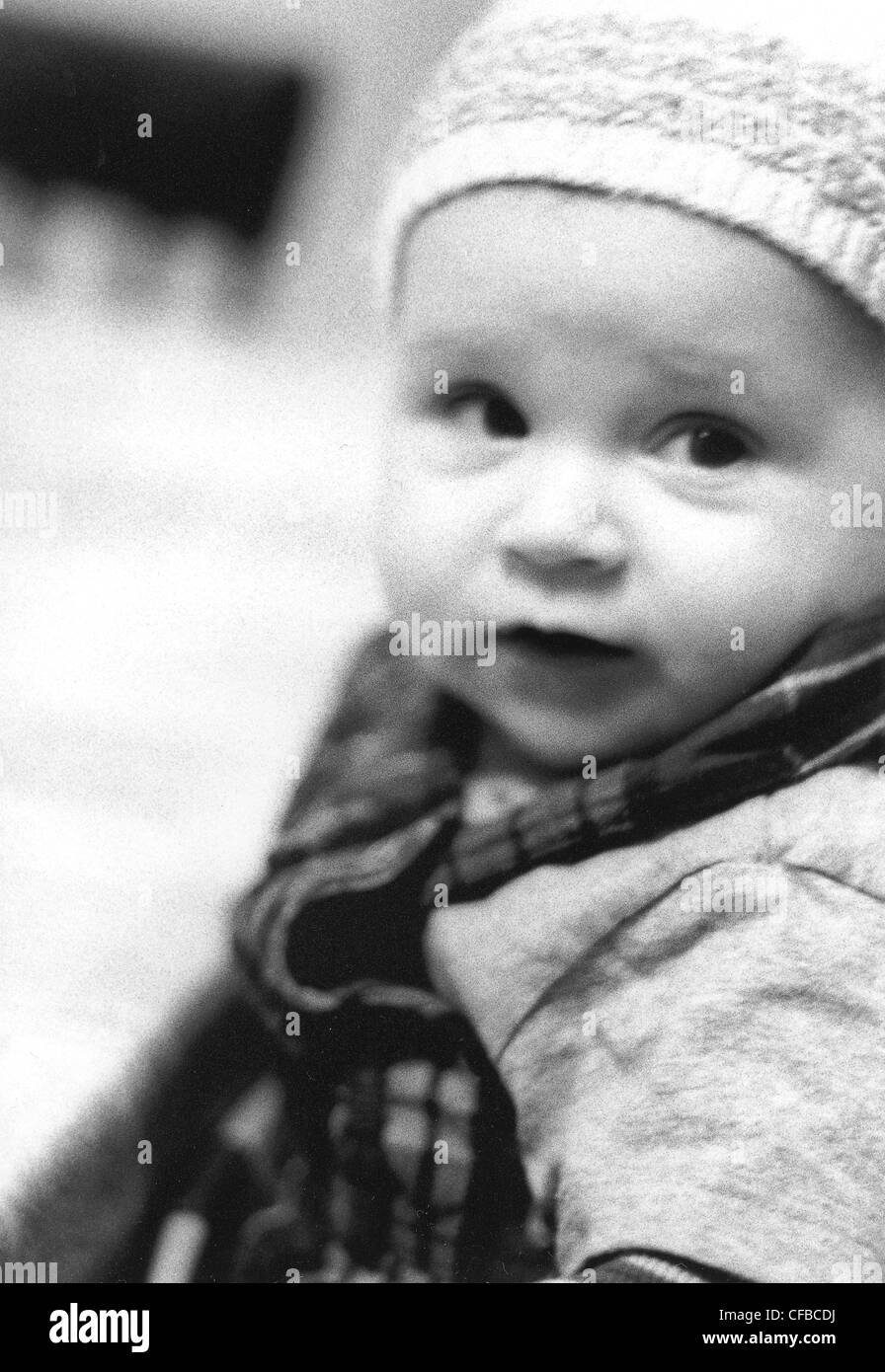 'FACES OF ALFI' Baby wearing knitted hat serious expression Stock Photo