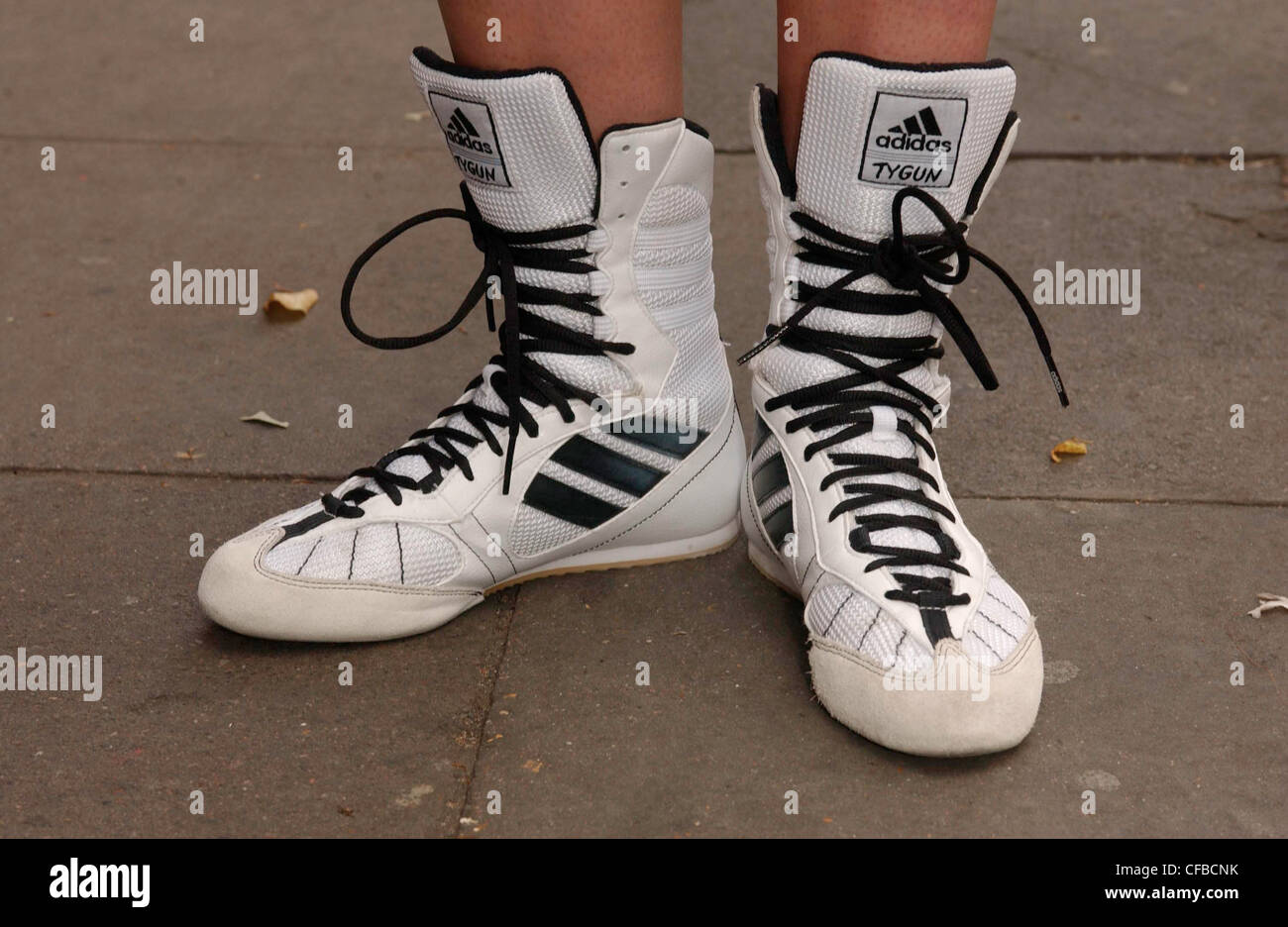 B London Street Fashion Cropped female feet wearing white Adidas Tygun  boots with black laces Stock Photo - Alamy