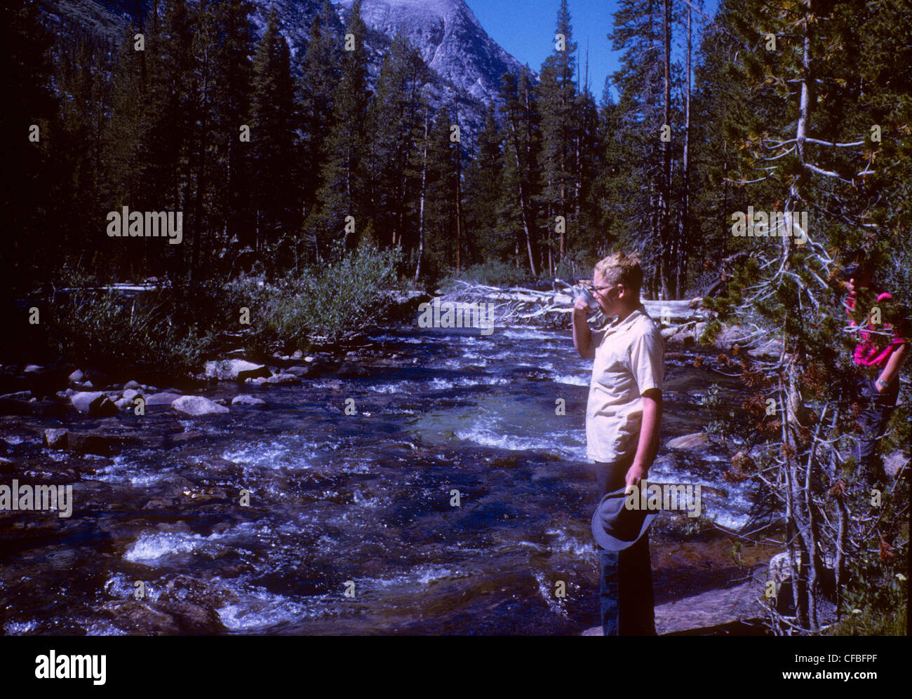 drinking fresh water from high sierra river backpacking california 1960s john muir trail Stock Photo