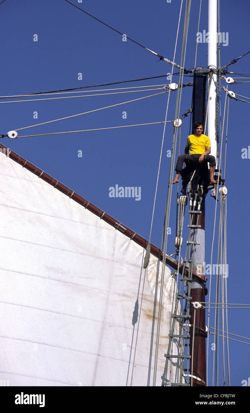 Sailor in rigging of French schooner 'Bel Espoir II' during the SAIL 2005 maritime event. Amsterdam, The Netherlands. Stock Photo