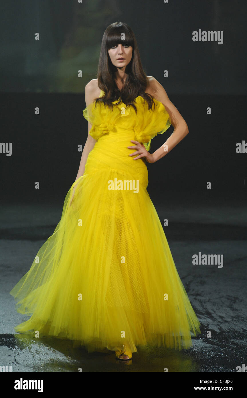 Givenchy Paris Haute Couture Spring Summer Model Irina Lazareanu very long brunette hair wearing bright yellow net and tule Stock Photo