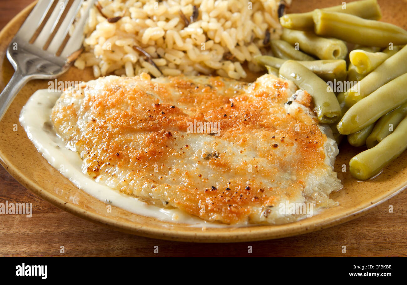 tilapia with parmesan sauce, rice and green beans Stock Photo Alamy