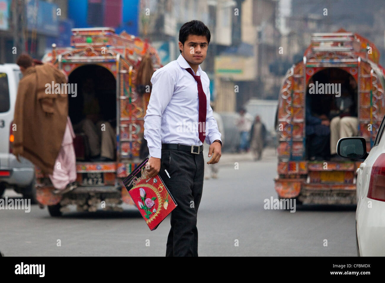 Student crossing the street in Islamabad, Pakistan Stock Photo